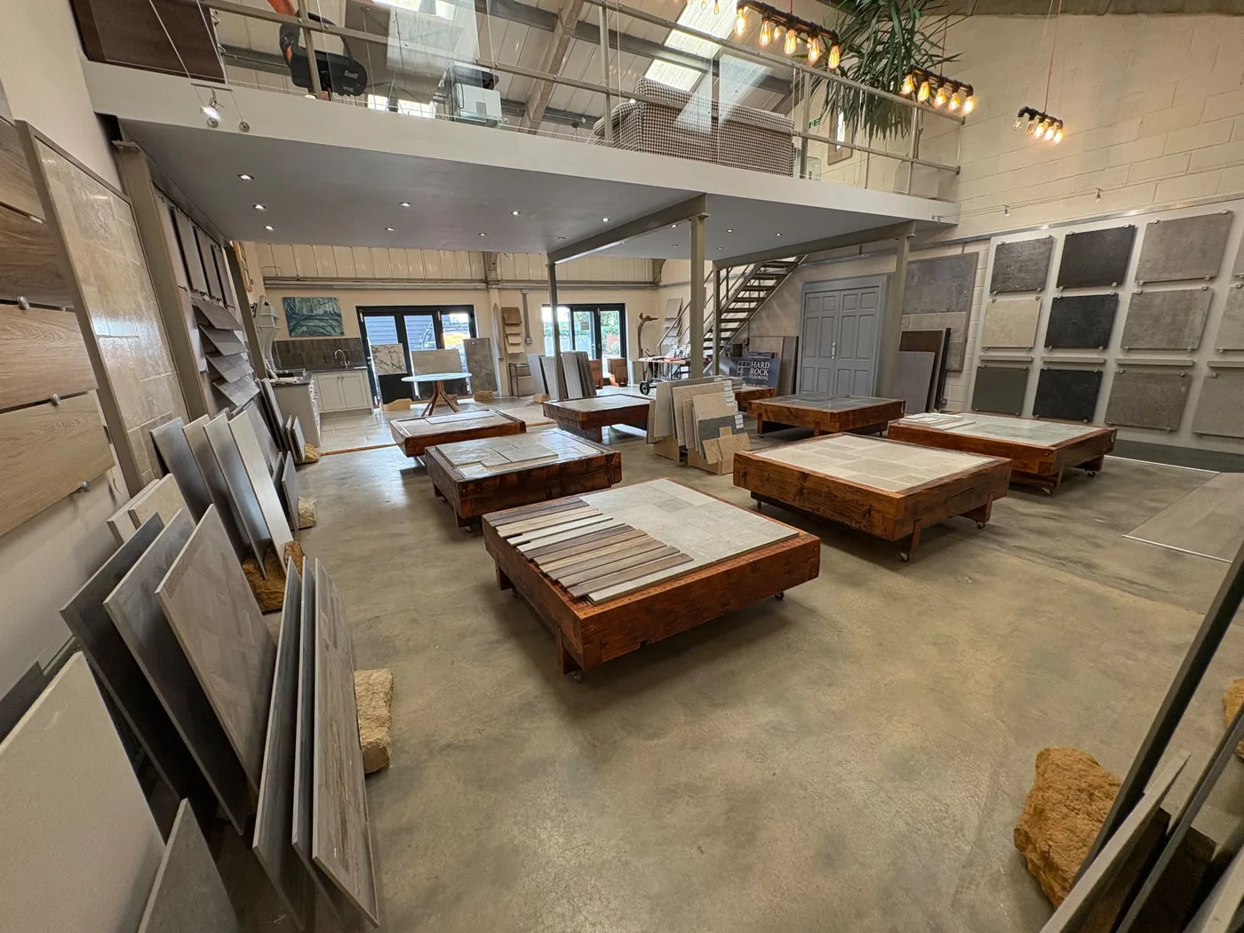 The showroom floor with display tables of stone and porcelain samples