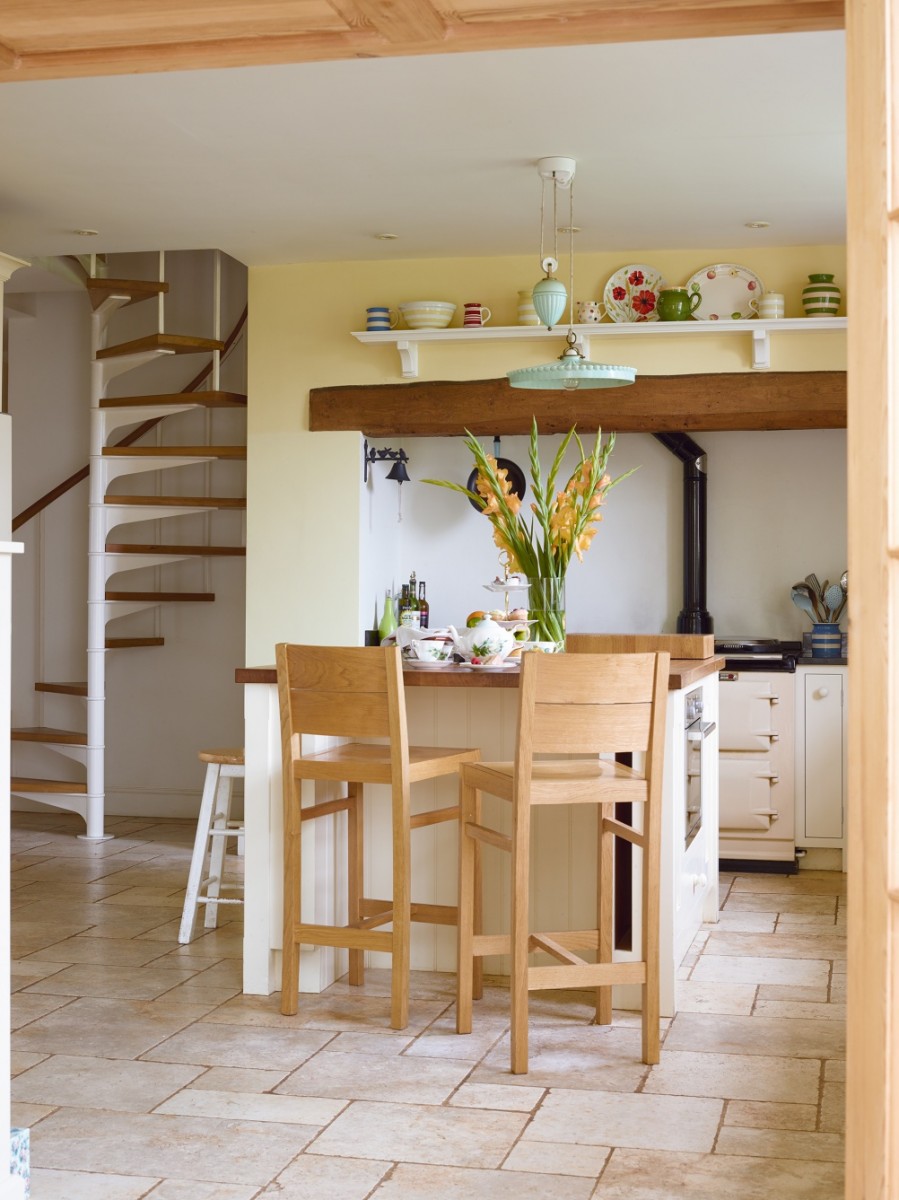 The units and worktops were made bespoke by Duncan Doig to fit the space, and the bar stools from Cygnet Interiors match the Shaker style perfectly. The units have been painted in Cooks Cream and the wall in Roman Ochre, both by Fired Earth. An old spiral staircase, sourced by the builders to replace the original one in the space, has been revived with new oak treads. Try Albion Design for a similar staircase. The limestone flooring from Hard Rock Flooring continues into the orangery